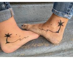 two feet with palm trees and birds on them