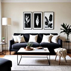 a living room with black couches and white rugs on the hardwood flooring