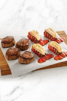 lobsters and crab cakes on a cutting board