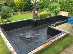 an empty pool in the middle of a garden