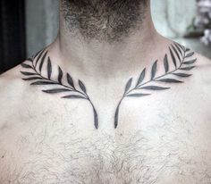 a man's chest is adorned with black leaves