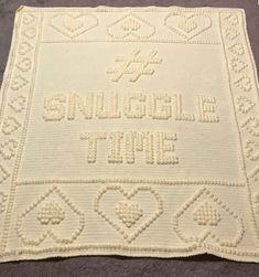 a crocheted blanket with the words smile, love and time written on it