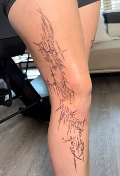 a woman's leg with tattoos on it and her legs showing the names of different cities