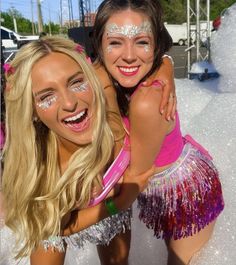 two young women dressed in costumes posing for the camera with their faces painted white and pink