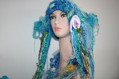 Totally unique! One in the world! Ready To Ship! Soft and fairy-like! Hand Made Freeform knitted forest fairy Hat! Perfect for any Mermaid! Embellished with beautiful freeform crochet spiral, and flowing, cascading yarns.  Beautiful watery dragonfly scarflette listed separately, thank you. Unique. One Of A Kind Wearable Art.  Makes a lovely gift! Comes Gift Wrapped! Lovely colours, blue, purple, lilac, pink, white, green, yellow tones.  You will be the only one in the world to wear this hand mad Whimsical Handmade Crochet Hat, Mermaid Hat, Spin Art, Cascade Yarn, Forest Fairy, Freeform Crochet, Yarn Art, Lovely Colors, Hat Making