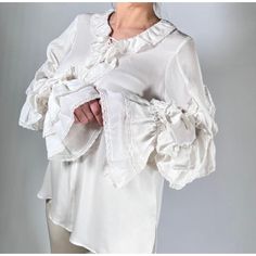 This Beautiful Ungaro Blouse Is Perfect For A Special Occasion. It Is Made From 100% Silk And Features A Ruffled Collar, Cuffs, And Placket. The Blouse Is Also Detailed With Delicate Lace Trim. It Is New With Tags. Size L, Please Review Photo Measurements To Confirm Fit. Petite Blouses, Ruffle Sleeve Blouse, Poncho Style, Silk Lace, Bow Detail Dress, Ruffled Collar, Flowy Blouse, Classic Chic, Lace Ruffle