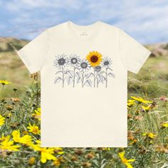 Elevate your style with our Minimalistic Sunflowers Unisex Tee, available in multiple colors and sizes. This charming tee features a minimalistic design of one-color sunflowers, offering a versatile and timeless look. #12 Boho Classic unisex jersey short sleeve tee fits like a well-loved favorite. Soft cotton and quality print make users fall in love with it over and over again. Ribbed knit collars to bolster shaping. Shoulders are tapered for a better fit over time. Dual side seams hold the garment's shape for longer. Fabric Details Made with 100% Airlume combed and ring-spun cotton, a lightweight fabric (4.2 oz/yd² (142 g/m²)) that is easy to layer, breathable. Perfect for active and leisure wear. Style Features The retail fit is perfect for casual and semi-formal settings. The crew neck Summer Floral Print T-shirt For Everyday, Floral Print T-shirt For Summer, Summer Cotton T-shirt With Sunflower Design, Relaxed Fit Cotton T-shirt With Sunflower Design, White Sunflower T-shirt For Summer, Spring Sunflower Design T-shirt In Relaxed Fit, Spring Cotton T-shirt With Sunflower Design, Spring Relaxed Fit T-shirt With Sunflower Design, Minimalistic Design