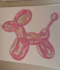 the pink dog is made out of beads