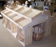 a small wooden house made out of pallet wood and some buckets on the floor