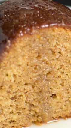 a close up of a piece of cake on a plate with caramel glaze