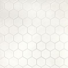 a white tiled wall with hexagonal shapes