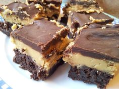 several pieces of chocolate and peanut butter brownie on a white plate with blue checkered cloth