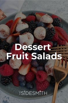 dessert fruit salads with powdered sugar and berries in a bowl next to a fork