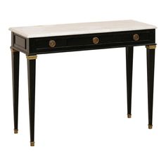 a black and white table with two drawers on one side, gold accents on the other