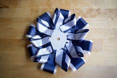 a large blue and white bow sitting on top of a wooden table