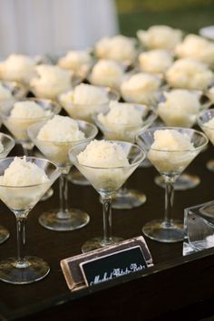 small martini glasses filled with ice cream on a table