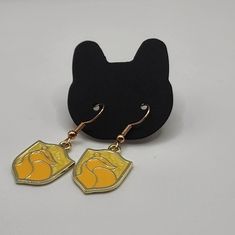 a pair of black and yellow cat earrings