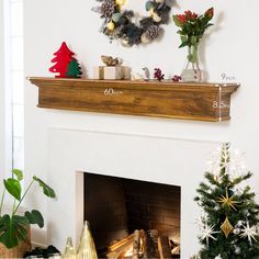 a fireplace decorated for christmas with decorations on the mantle