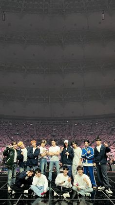 a group of young men standing on top of a basketball court next to each other