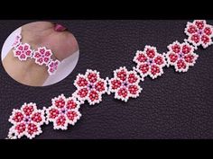 the beaded bracelet is decorated with pink and red beads on black leather surface, next to an image of a woman's hand