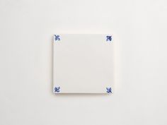 a square white plate with blue flowers on it