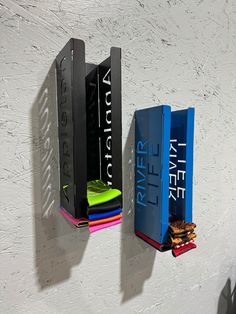 three books are hanging on the wall next to each other, and one is empty