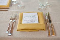 a place setting with silverware and napkins