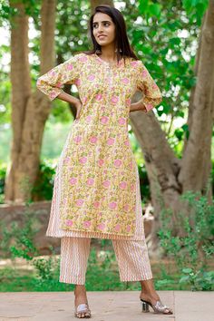 This two piece set is an ode to Ethnic Charm which features a Hand Block Printed Kurta and Pants. The kurta is double layered with the bottom layer outstretching the upper one. The kurta is embellished with threadwork and beautiful sequins over the sleeves and around the circumference of the neck. You will truly swirl and sway in this gorgeous ensemble Detail: This is 2 Pc. Set Kurta set : cotton hand block printed double layered  kurta set  Color : Yellow, pink  Composition : 100%  Cotton (Prem Yellow Cotton Sharara With Printed Motifs, Yellow Cotton Palazzo Set With Printed Motifs, Yellow Cotton Anarkali Set With Printed Motifs, Yellow Mulmul Palazzo Set With Printed Motifs, Yellow Printed Mulmul Palazzo Set, Yellow Mulmul Palazzo Set For Navratri, Yellow Cotton Palazzo Set For Navratri, Navratri Yellow Cotton Palazzo Set, Yellow Cotton Anarkali Set With Straight Kurta