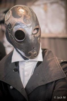 a person wearing a mask and jacket