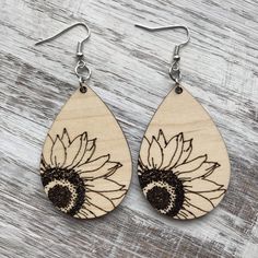 wooden earrings with an image of a sunflower on it