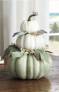 three white pumpkins stacked on top of each other