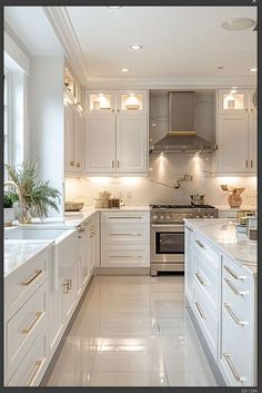 a large kitchen with white cabinets and marble counter tops, along with stainless steel appliances