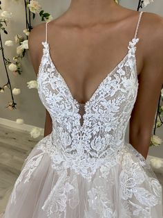 the back of a wedding dress with white flowers