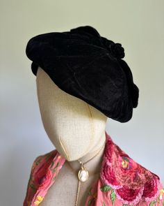 This beautiful vintage hat features beret styling, with a fitted band and soft, floppy top accented with a top-knot bow. Delicate and feminine with striking black silk-velvet to frame the face. Excellent vintage condition. Era: 1930s  Label: black and white hatters and milliners union label Pictured on a mannequin with a 21 inch head circumference Elegant Adjustable Black Beret, Elegant Black Beret For Party, Elegant Fall Beret, Vintage Black Cloche Hat For Fall, Elegant Fall Party Beret, Elegant Evening Cloche Hat For Fall, Vintage Black Beret For Fall, Elegant Adjustable Fall Beret, Adjustable Elegant Beret For Fall