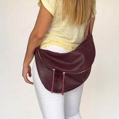 A favourite and classic leather fanny pack for both women and men that tends to become a timeless design. This large sling bag stands out for the quality of its leather, for the capacity and for the stylish buckle used on the leather strap. It is a 3 style purse as you can wear it as a crossbody bag, as a shoulder bag and as a backpack. The large compartment is ideal to fit all your daily essentials like a water bottle, a make up case, wallet , phone, notebook and more. Ideal for travelling, for Woman Sling Bag, Oversized Purse, Red Leather Bag, Leather Fanny Pack, Bag Stand, Chest Bag, Hip Bag, Classic Leather, Fanny Pack