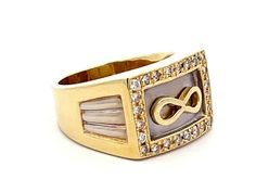 a gold and white ring with an infinite sign in the center, surrounded by diamonds