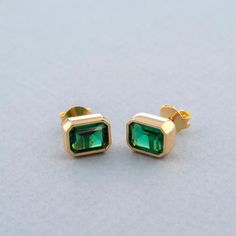 Introducing our exquisite May Birthstone Emerald Stud, beautifully crafted from high-quality 14K solid gold. These stunning earrings showcase vibrant emerald birthstone that are perfect for adding a touch of elegance to any outfit. The combination of the rich green emerald and the bright gold setting creates a timeless look that enhances any wardrobe. The May Birthstone Emerald Stud earrings are not only a statement piece but also carry the significance of renewal and growth, making them a thoug Formal Rectangular Earrings With May Birthstone, 14k Gold Emerald Cut Earrings For Gift, Emerald Cut Yellow Gold Earrings For Gift, Rectangular Gemstone Earrings For May Birthstone, Yellow Gold Emerald Earrings For Gift, Classic Earrings With Rectangular Stone For Gift, Gold Emerald Rectangular Earrings, Gold Rectangular Emerald Earrings, Emerald Rectangular Earrings For May Birthstone