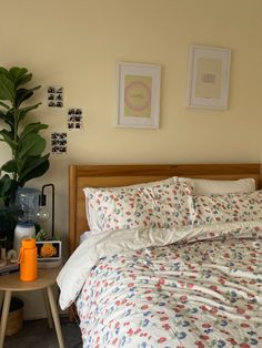 a bed sitting next to a table with a lamp on top of it in a bedroom