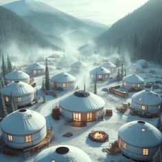 a group of yurts in the snow surrounded by pine trees and foggy mountains