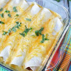 a glass casserole dish filled with cheese and green garnish