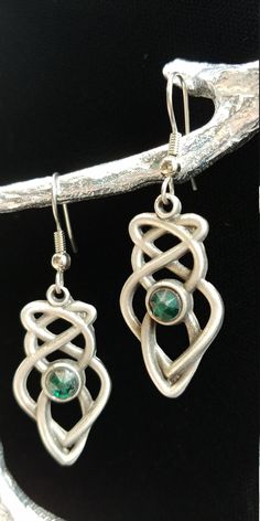 "Hand cast and hand finished out of lead-free Britannia Pewter. This pair of Celtic Knot earrings measures 1 1\\/4\" x 5\\/8\" and the earring post is surgical steel. Matching necklace is also available. I have more than one item in stock, if you require more, please contact me. History of Celtic Knots Celtic knots or Celtic interlace are ornamental patterns that first became associated with Celtic people in the early Celtic Church where they were used to decorate Bible. Monks used the Celtic kn Symbolic Nickel-free Teardrop Jewelry, Green Symbolic Nickel-free Jewelry, Symbolic Hypoallergenic Metal Jewelry, Symbolic Metal Jewelry With Matching Earrings, Silver Pewter Earrings As Gift, Silver Pewter Earrings For Gift, Unique Pewter Jewelry For Gifts, Symbolic Hand Cast Pewter Jewelry, Hand Cast Silver Dangle Earrings