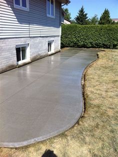 a concrete patio in front of a house