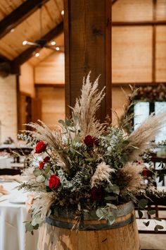 a wooden barrel filled with flowers and greenery