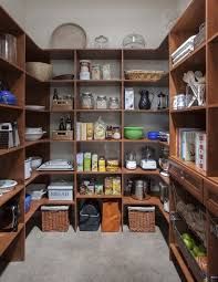 an organized pantry with lots of wooden shelves