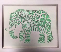 an elephant made out of cut paper in a frame