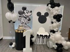 a mickey mouse themed birthday party with black and white balloons