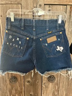 Wrangler "DAMN STRAIT" Cut Offs with Faux Rhinestones are something special!!  The left pocket not only has a bleached in "Damn Strait" , but Faux Rhinestones adorn the pocket to bring that bling!!  The SV logo patch is on every pair !!  These are the 13MWZ style in size 28 in Men's! ( Most would be a 24 in a Women's  Jean )  ** The 13MWZ style does not stretch , and these are in men's , take into account women have hips to calculate the best size for you !! ** ** MEASURE YOUR WAIST STRAIGHT ACROSS THE WAIST OF JEANS LAID FLAT- TAKE THAT NUMBER AND TIMES BY 2! THESE ARE 14 x2 =28! ** ** In calculating sizes you may need to go up 3- 4 sizes  EX: IF YOU ARE A 24 and go up 4 sizes you would be a 28 in Men's Wranglers (Give or take ,this is a base for which you can calculate as close to your s Sv Logo, Cut Offs, Something Special, Cut Off, Patch Logo, Women Jeans, Take That, Bring It On, Womens Shorts