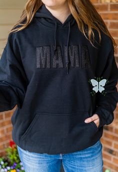 Elevate your mom style with our Mama Black Embroidered Glitter Vinyl Crewneck Sweatshirt! Made with high-quality materials, this cozy black sweatshirt is stitch filled embroidered with the word "Mama" in a bold and chic font. The shimmering black glitter vinyl adds a touch of glamour, while the crewneck design provides comfort and style. Perfect for any mama looking to show off her love and style at the same time! THIS IS A PHYSICAL PRODUCT. CREWNECK IS UNISEX. CREWNECK IS EMBROIDERED. CREWNECK Black Embroidered Crew Neck Sweatshirt, Black Crew Neck Hoodie With Embroidered Graphics, Black Embroidered Text Sweatshirt Crew Neck, Black Embroidered Hooded Sweatshirt, Black Embroidered Logo Crew Neck Sweatshirt, Rhinestone Hoodie, Black Stitch, Nurse Hat, Crewneck Design