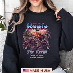 a woman wearing a black sweatshirt with an image of the devil on it