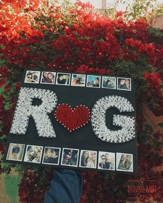 a person holding up a sign that says rcg with photos and hearts on it